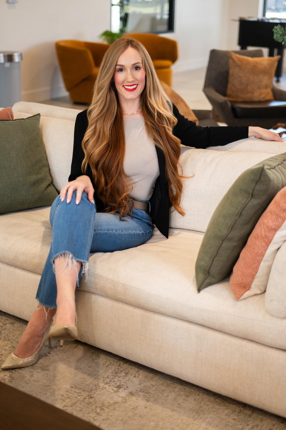 Crystal Hobbs sitting in gorgeous living room, Realtor Beachside Luxury